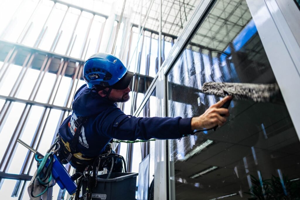 HPA rope access technician cleaning high-rise windows in Brisbane